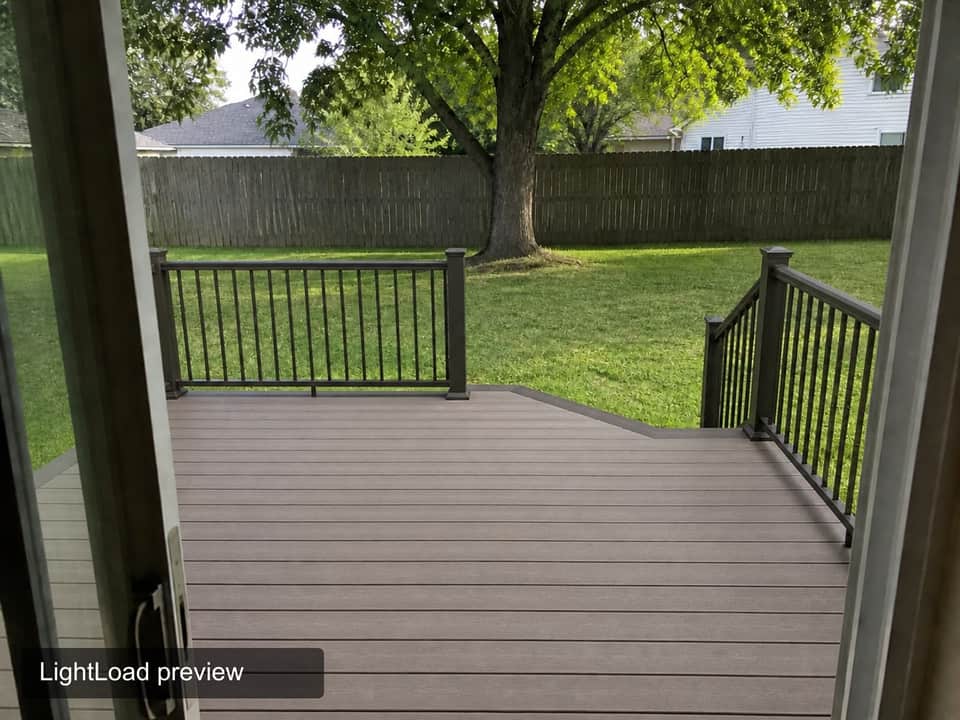 Sample AI preview of the same backyard with a composite deck and black railing, watermarked “LightLoad preview”